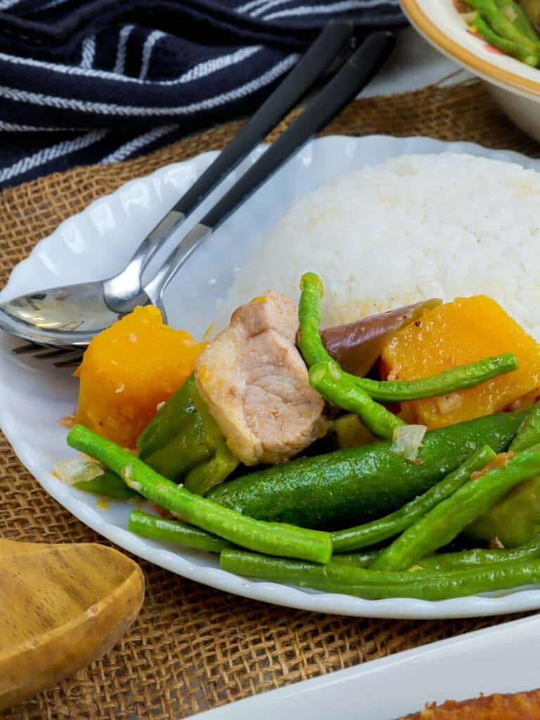 pinakbet with steamed rice on a white plate