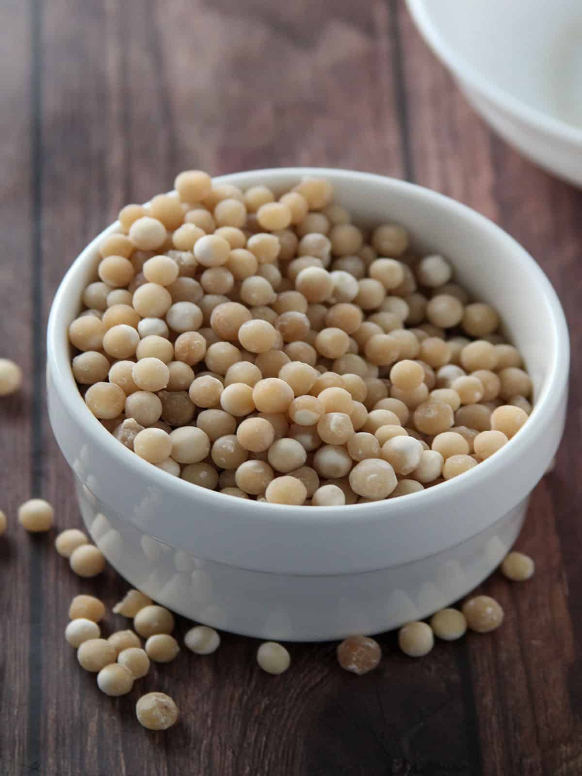 dry sago pearls in a white bowl