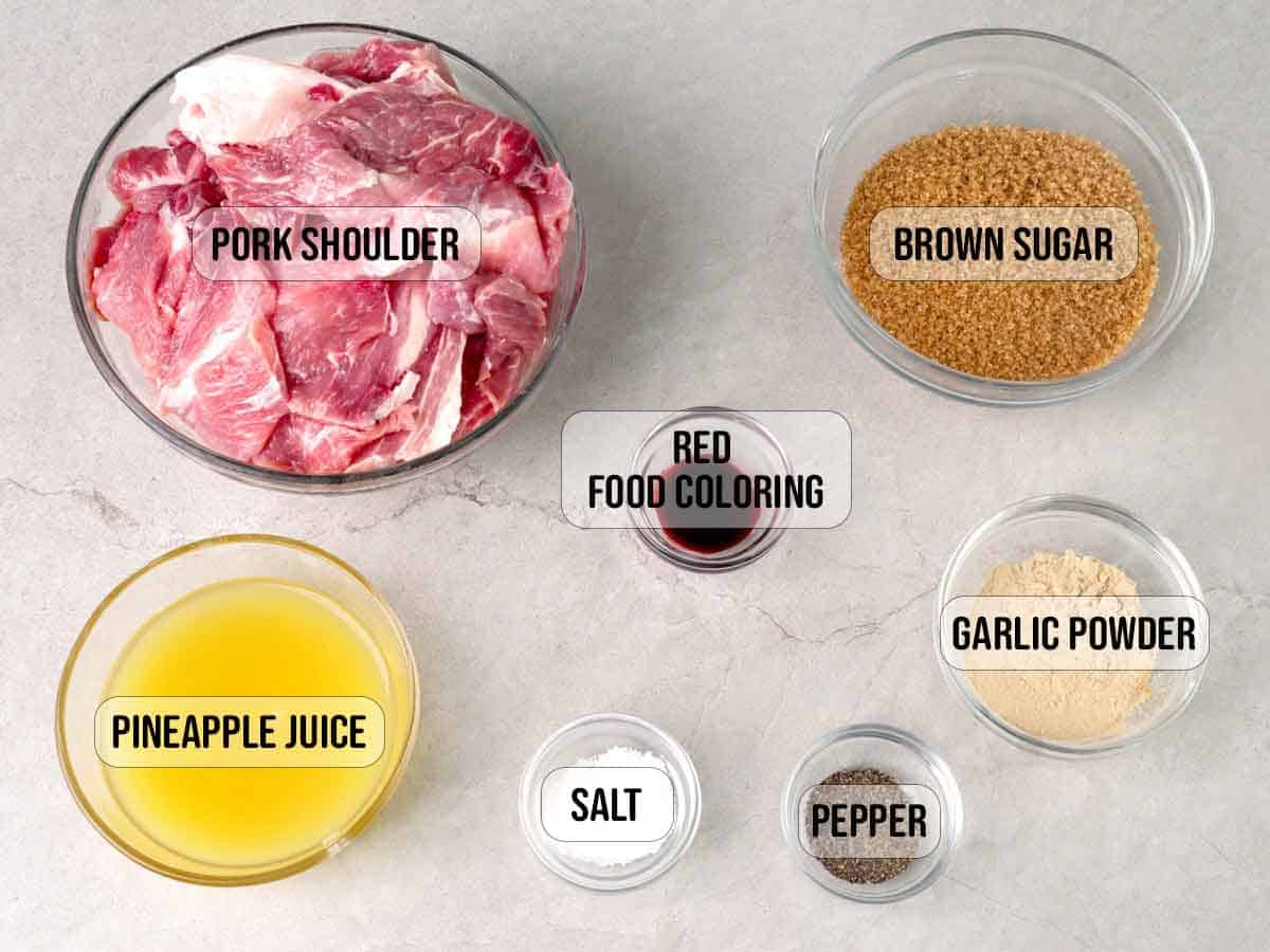 sliced pork, pineapple juice, brown sugar, garlic powder, salt, pepper, red food coloring in bowls.