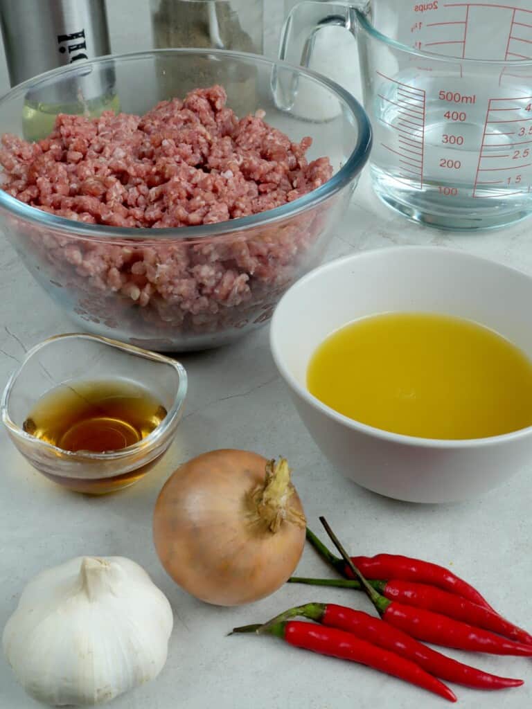 ground beef, calamansi juice, onion, garlic, chili peppers, fish sauce, water in bowls