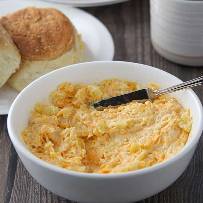 cheese pineapple spread in a white bowl with pandesal on the side