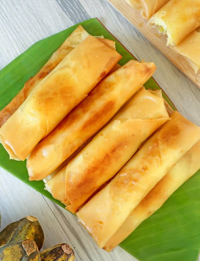 fried lumpiang saging on a banana-lined dish