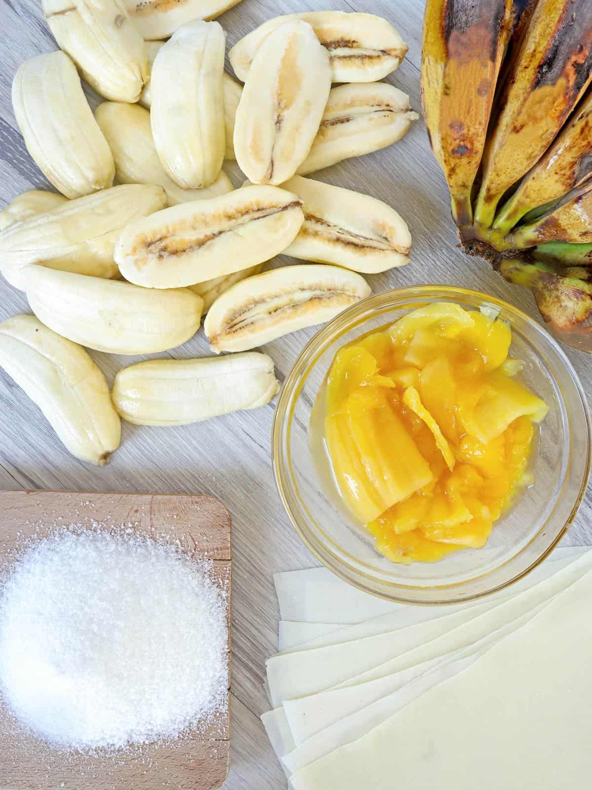 peeled and sliced saba bananas, sweetened jackfruit, sugar, lumpia wrappers