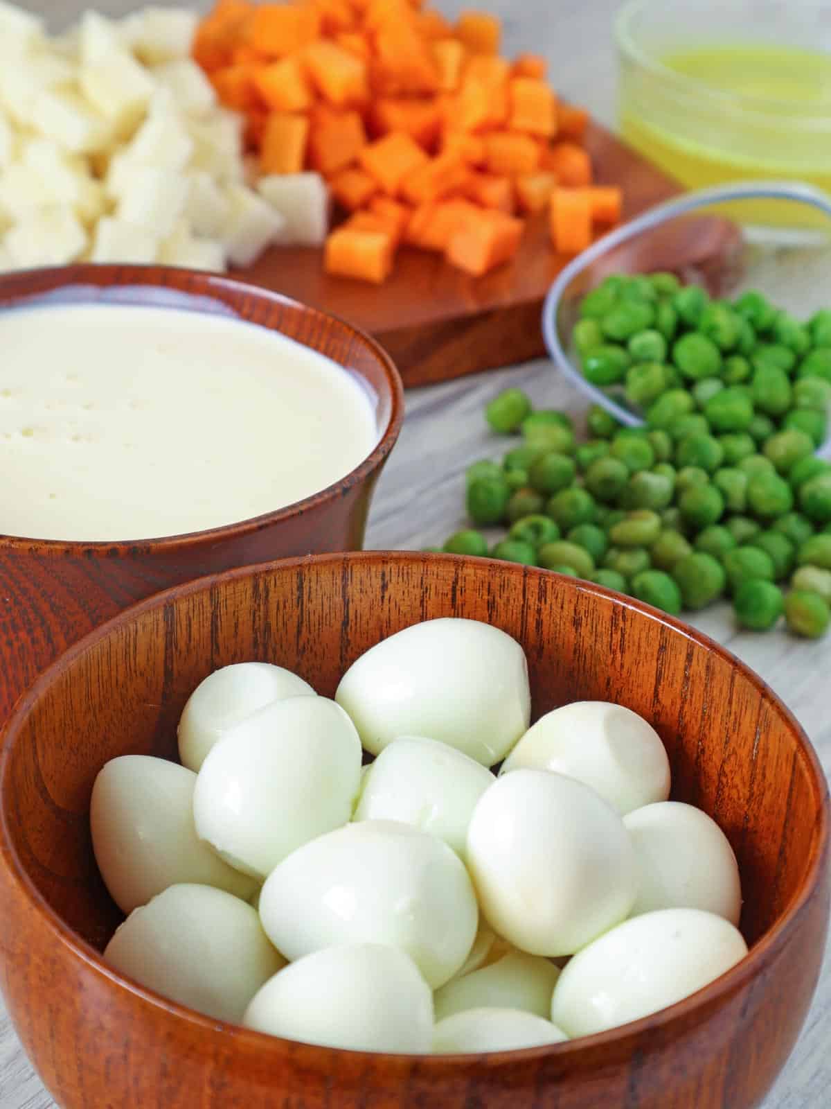 peeled hardboiled quail eggs, green peas, diced carrots, diced singkamas, heavy cream