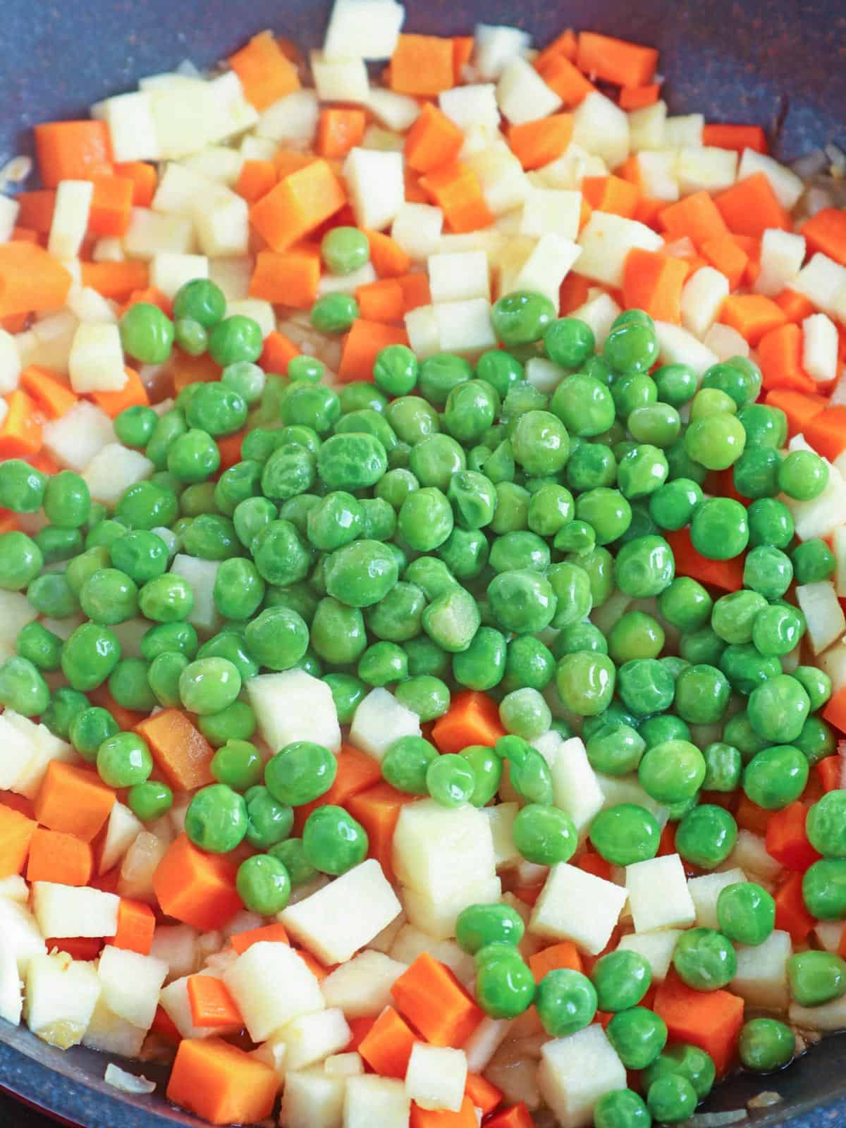 making sipo eggs with carrots, green peas, singkamas