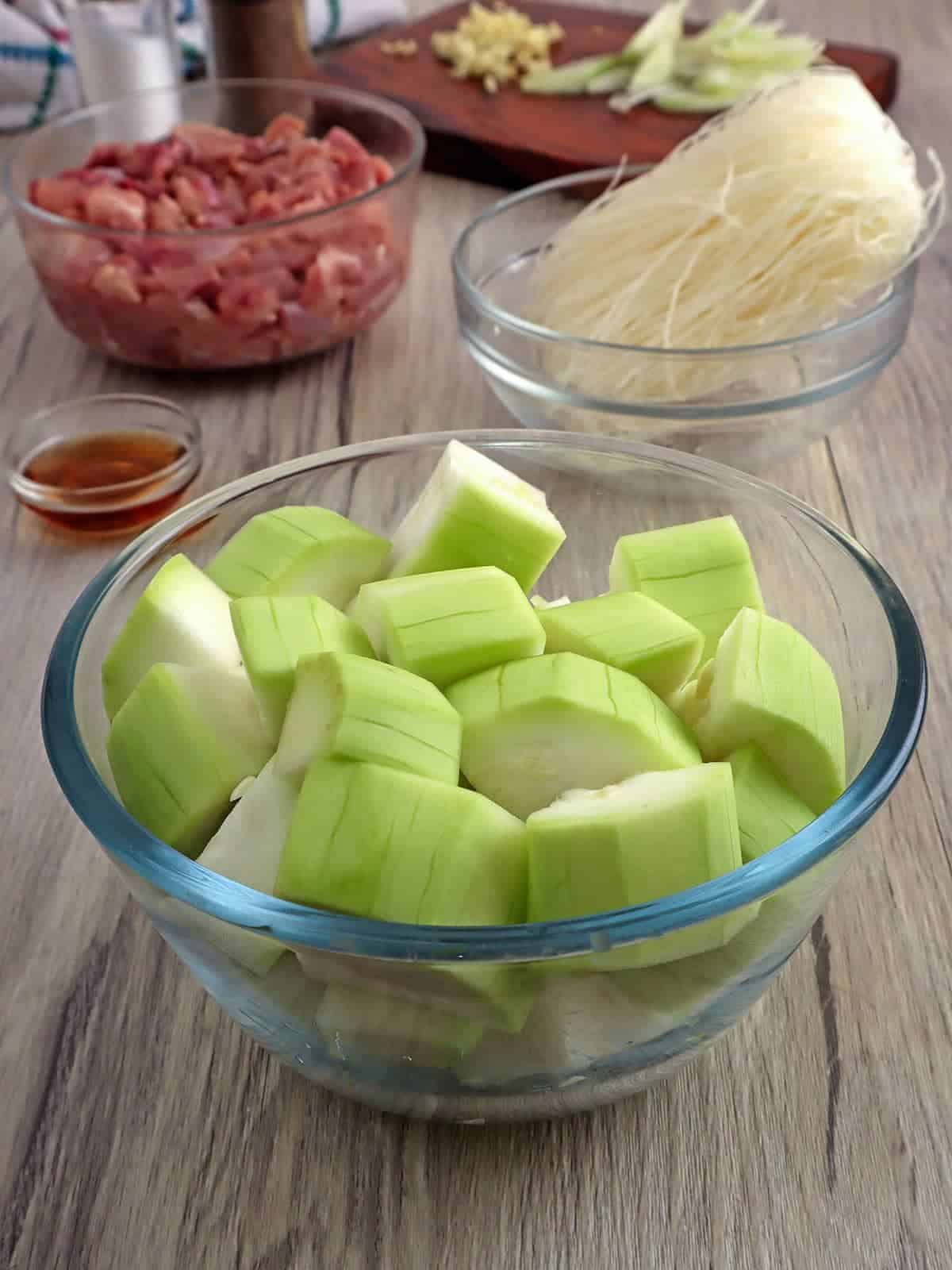 peeled and cubed upo, diced chicken thighs, cellophane noodles, fish sauce in individual bowls