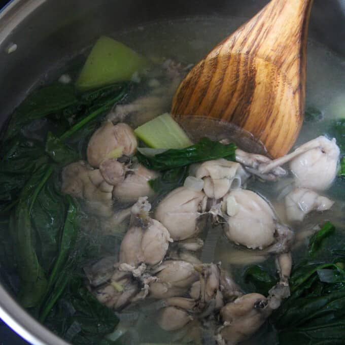 serving Tinolang Palaka from a pot with a wooden spoon.