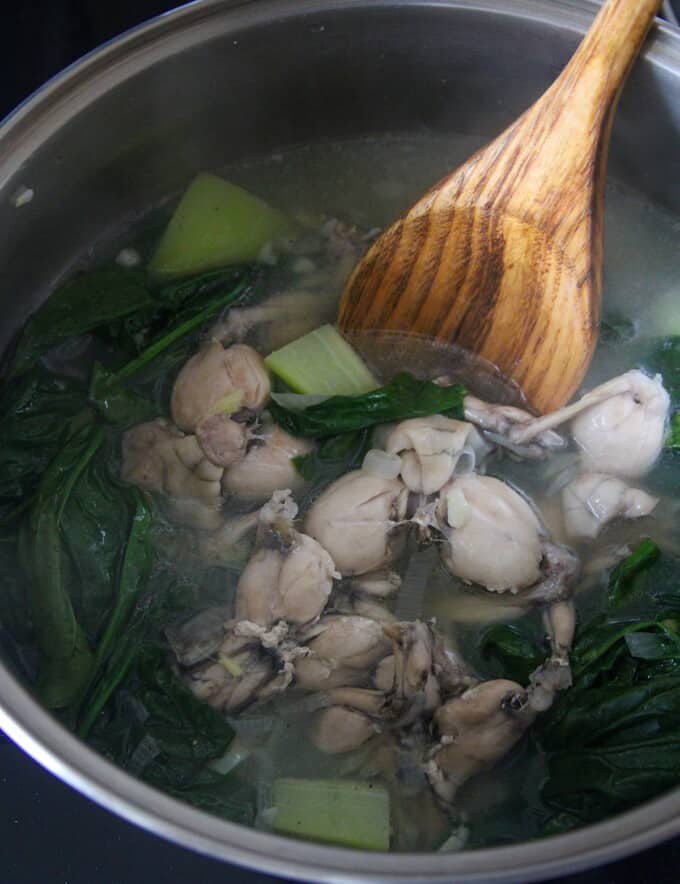 serving Tinolang Palaka from a pot with a wooden spoon.