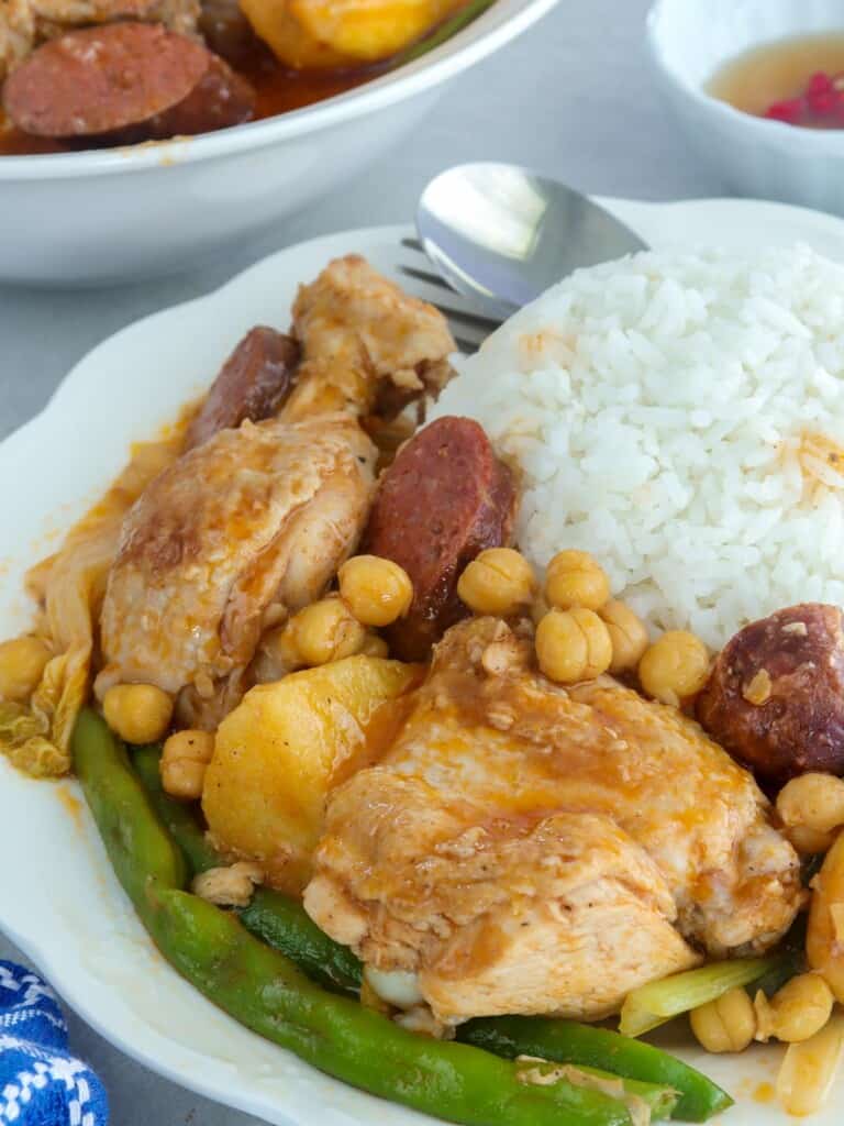 pocherong manok with steamed rice on a plate