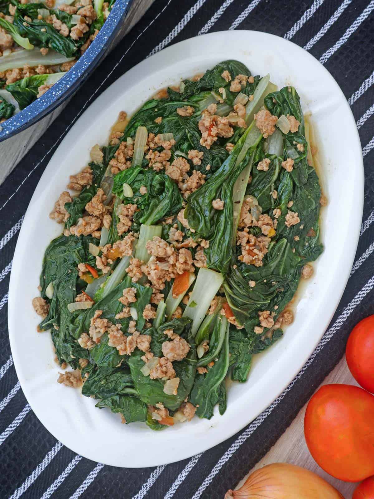 sauteed pechay and ground pork on a serving platter