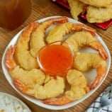 Camaron Rebosado on a platter with a small bowl of sweet and sour dipping sauce
