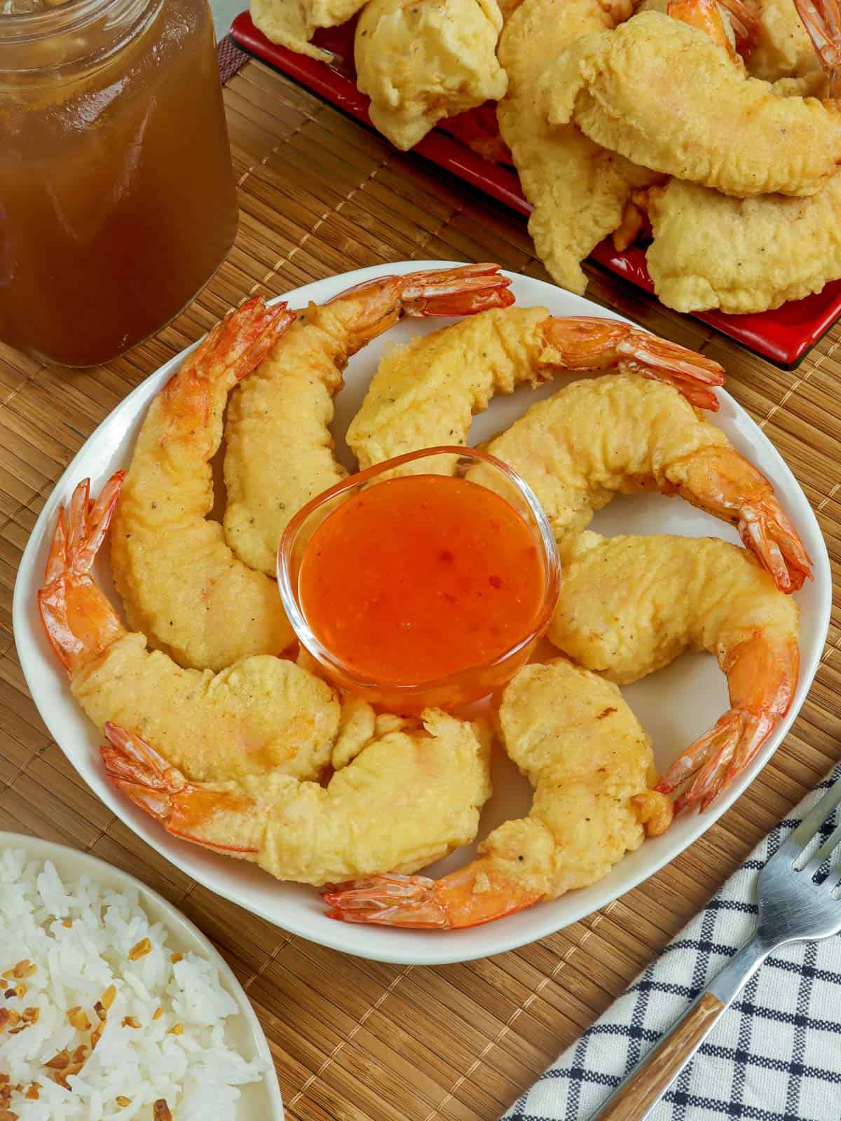 Camaron Rebosado on a platter with a small bowl of sweet and sour dipping sauce