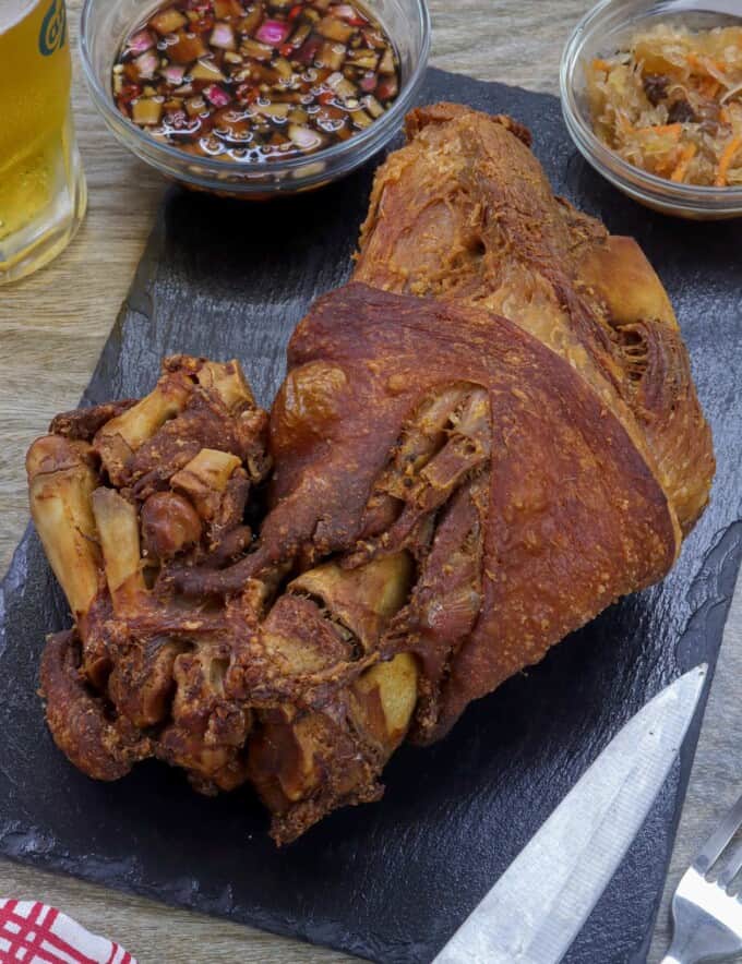 crispy pata on a cutting board.