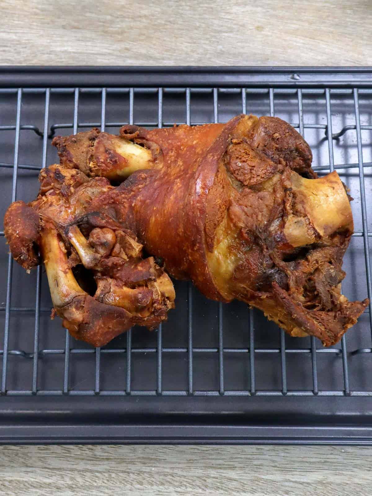 Crispy Pata on a wire rack.