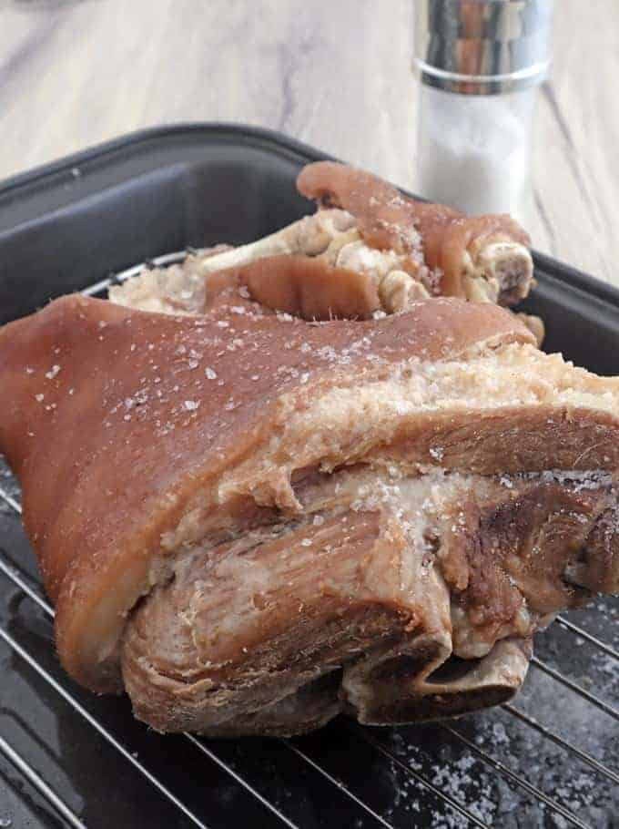 boiled pork leg on a wire rack seasoned with salt