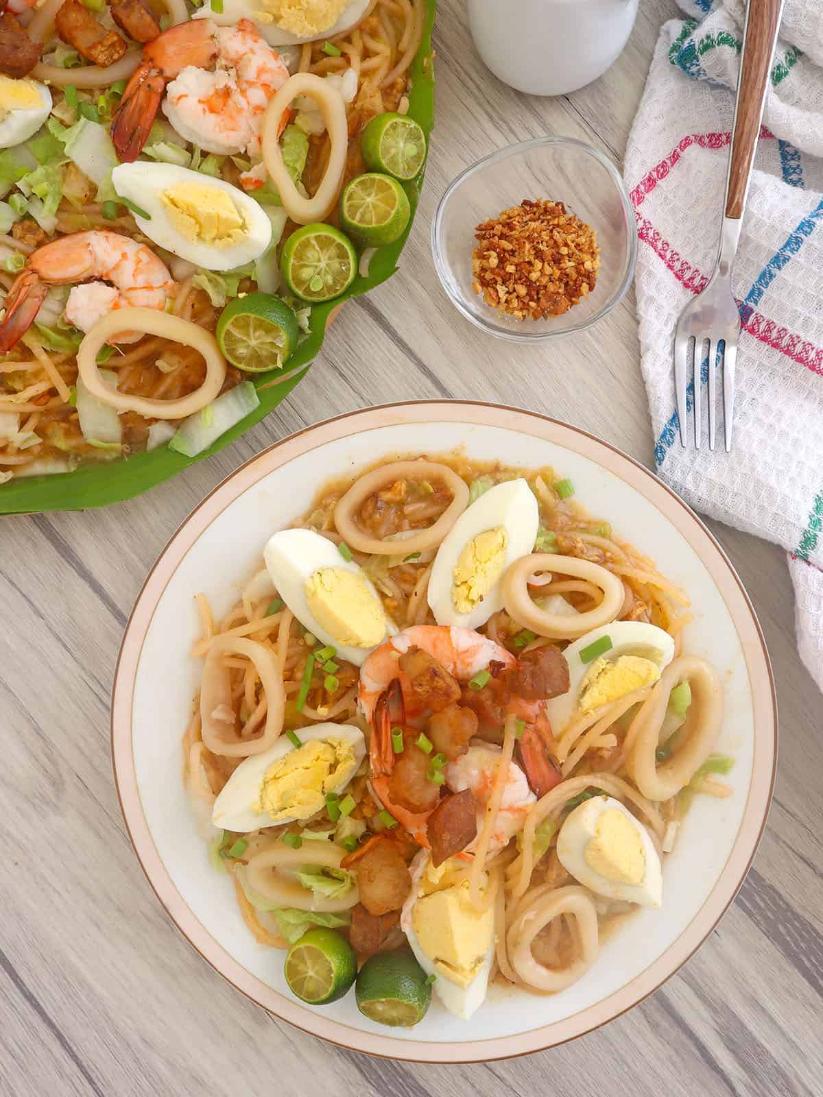 Pancit Malabon on a white serving plate