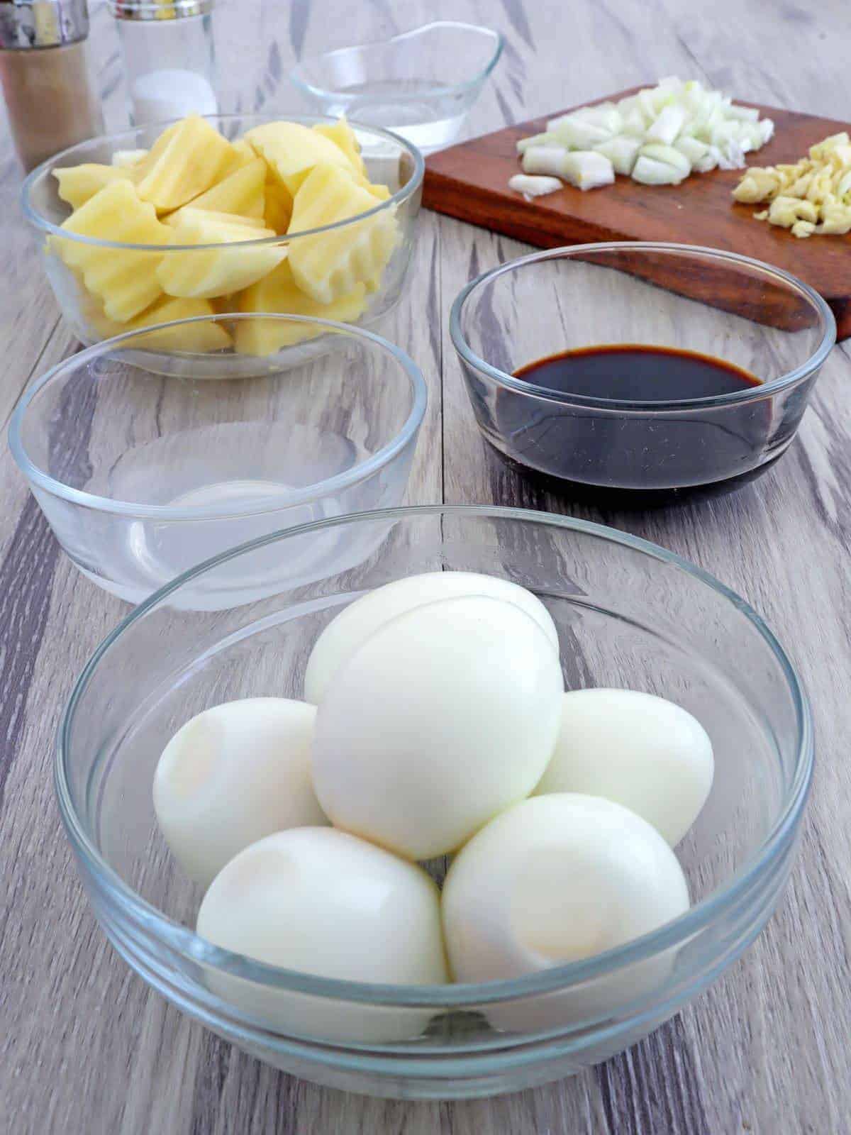 peeled hard-boiled eggs, soy sauce, cubed potatoes, vinegar, chopped onions, minced garlic 