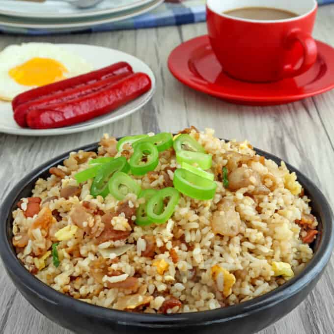 Bacon Fried Rice in a bowl with a side of fried egg and hotdogs