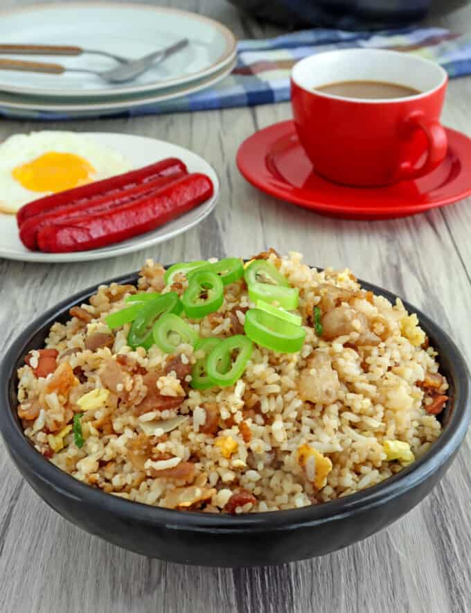 Bacon Fried Rice in a bowl with a side of fried egg and hotdogs