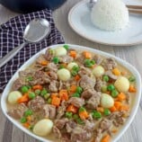 Liver and Gizzard with Sweet Peas in a serving bowl with a side of steamed rice