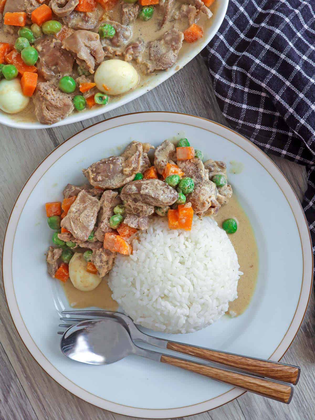 atay at balunbalunan with steamed rice on a white plate