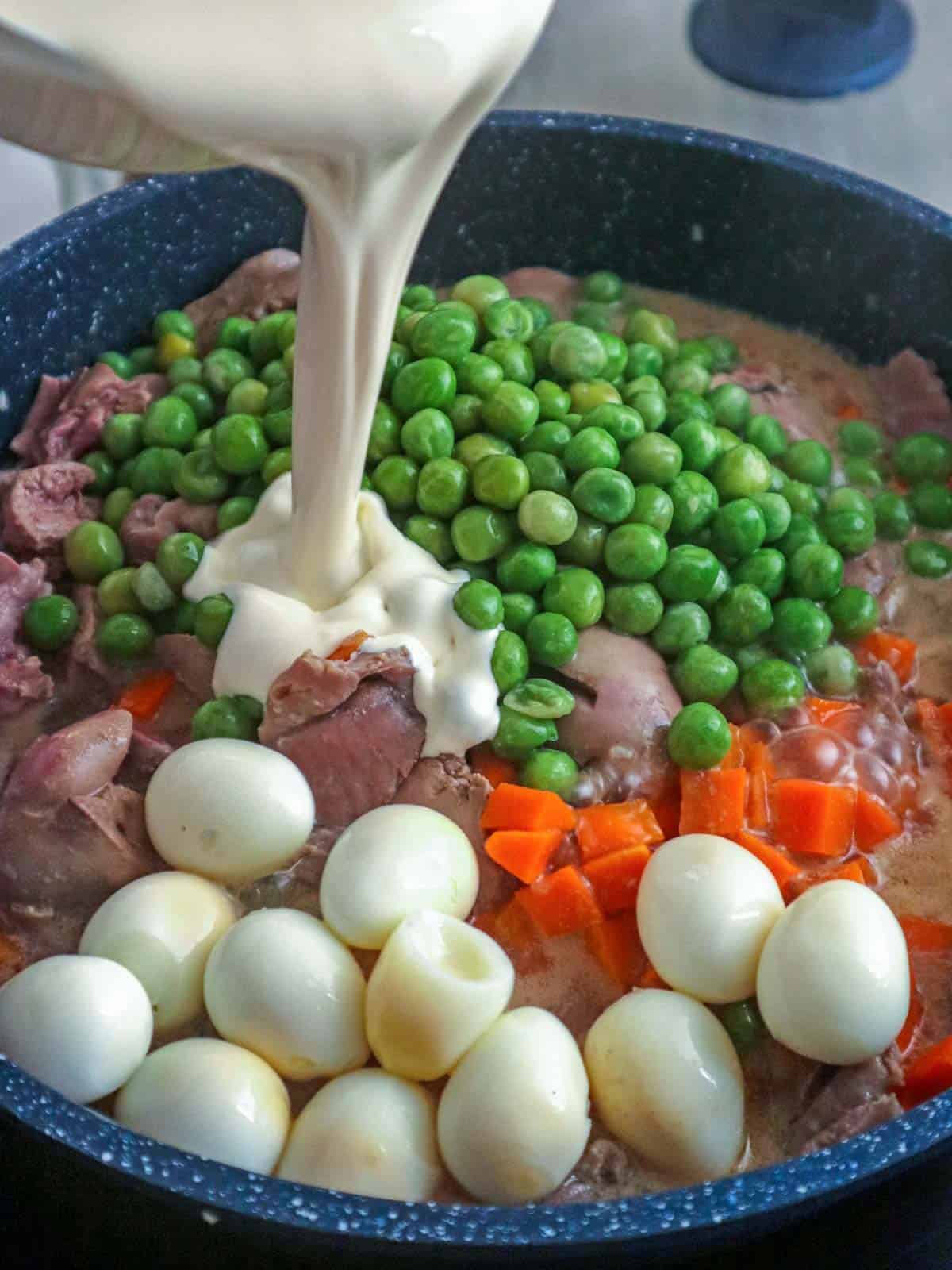 adding cream to pan of liver and gizzard with sweet peas