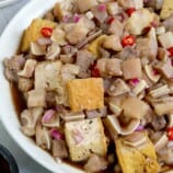 tofu and pork with a spicy vinegar dressing in serving bowl