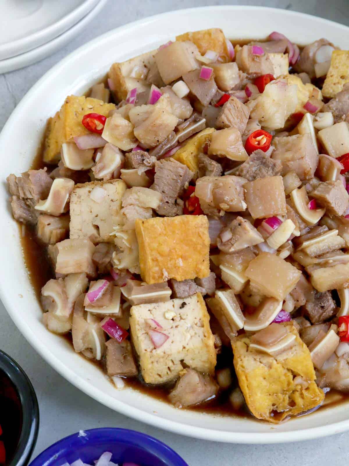 tofu and pork with a spicy vinegar dressing in serving bowl