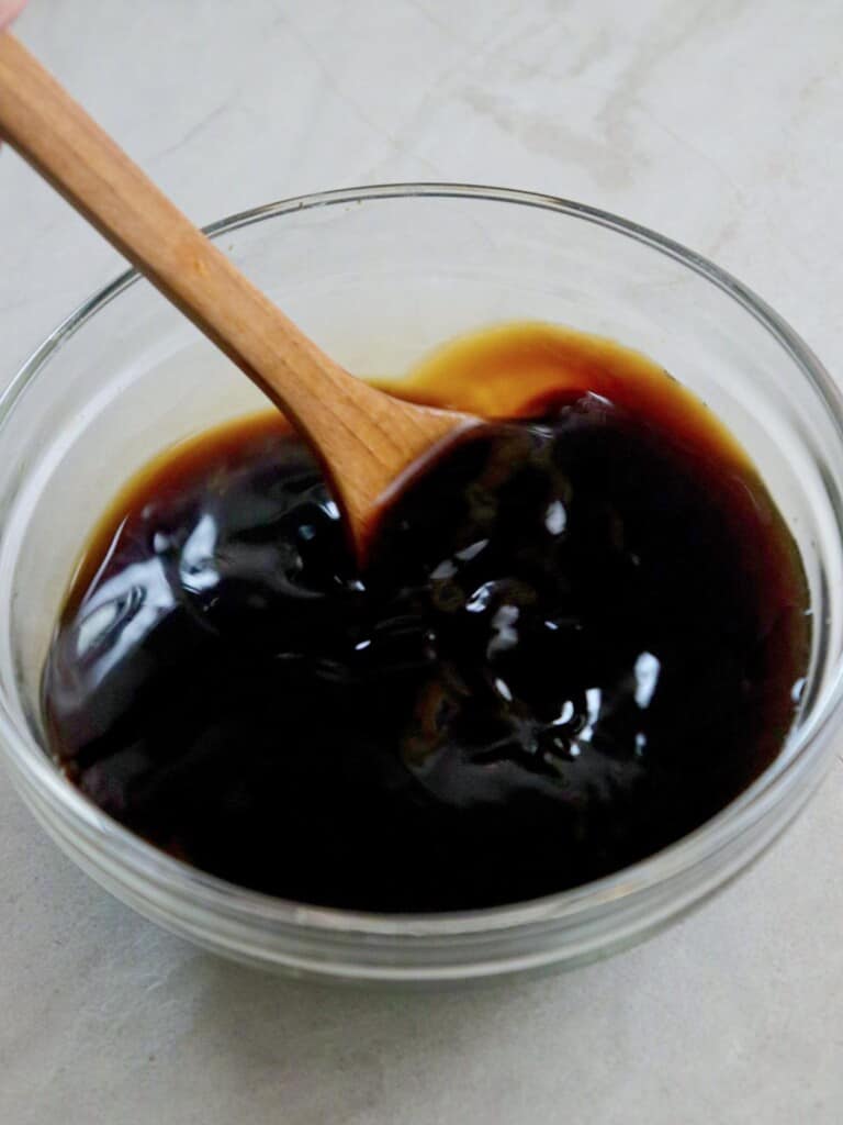 mixing calamansi juice, soy sauce, oyster sauce, and sugar in a bowl