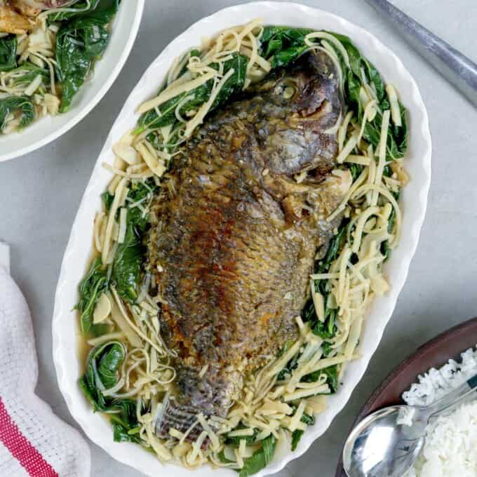 Dinengdeng na Saluyot at Labong with fried tilapia in. serving bowl.