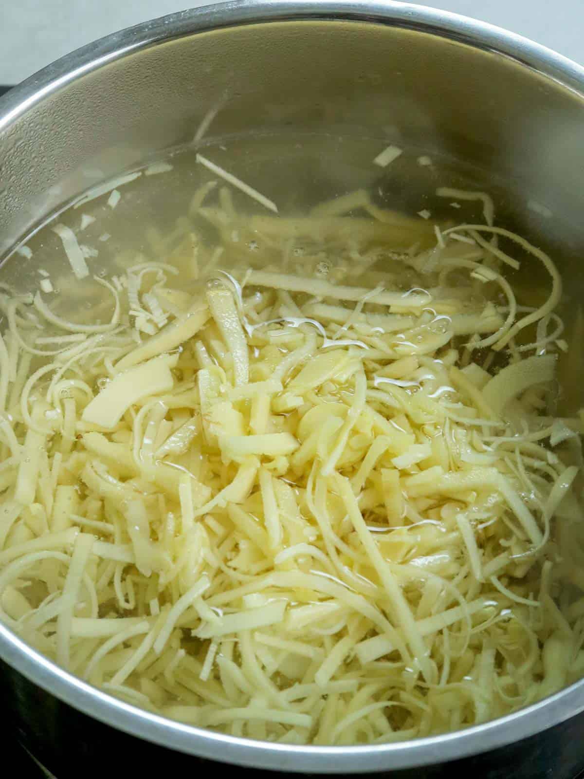 boiling young bamboo shoots in a pot of water.