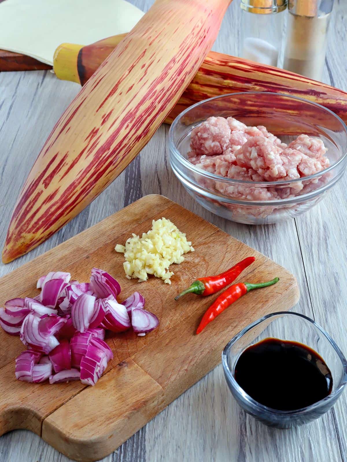 banana hearts, onions, garlic, chili peppers, ground pork, oyster sauce, salt, pepper, spring roll wrappers