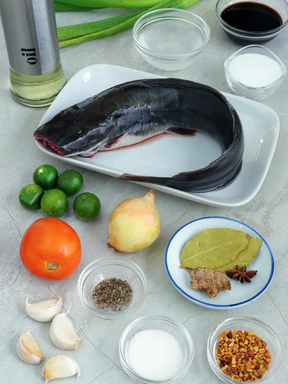 whole catfish, tomato, onion, garlic, brown sugar, calamansi, salt, ginger, peppercorns, bay leaves, vinegar, soy sauce