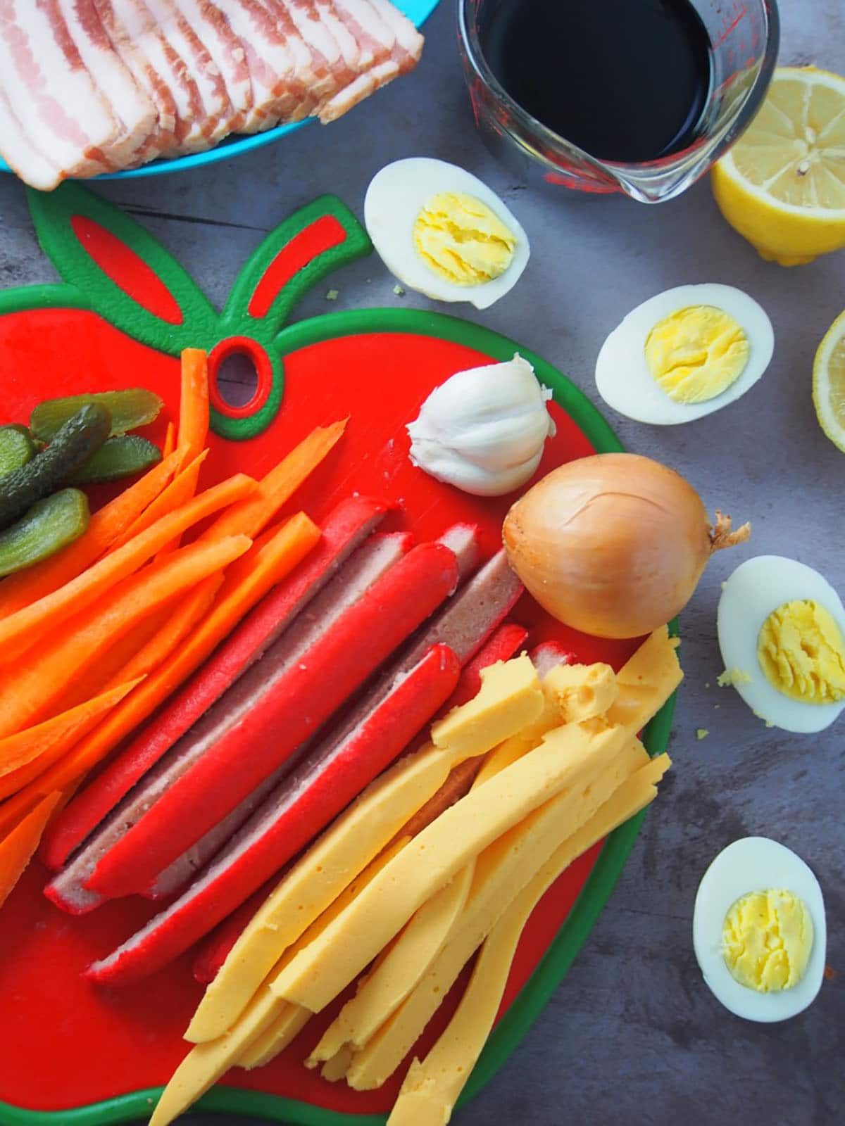 sliced hot dogs, cheese, carrots, hard boiled eggs, soy sauce