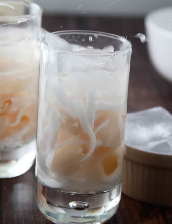 adding ice to glass of Buko Lychee Juice