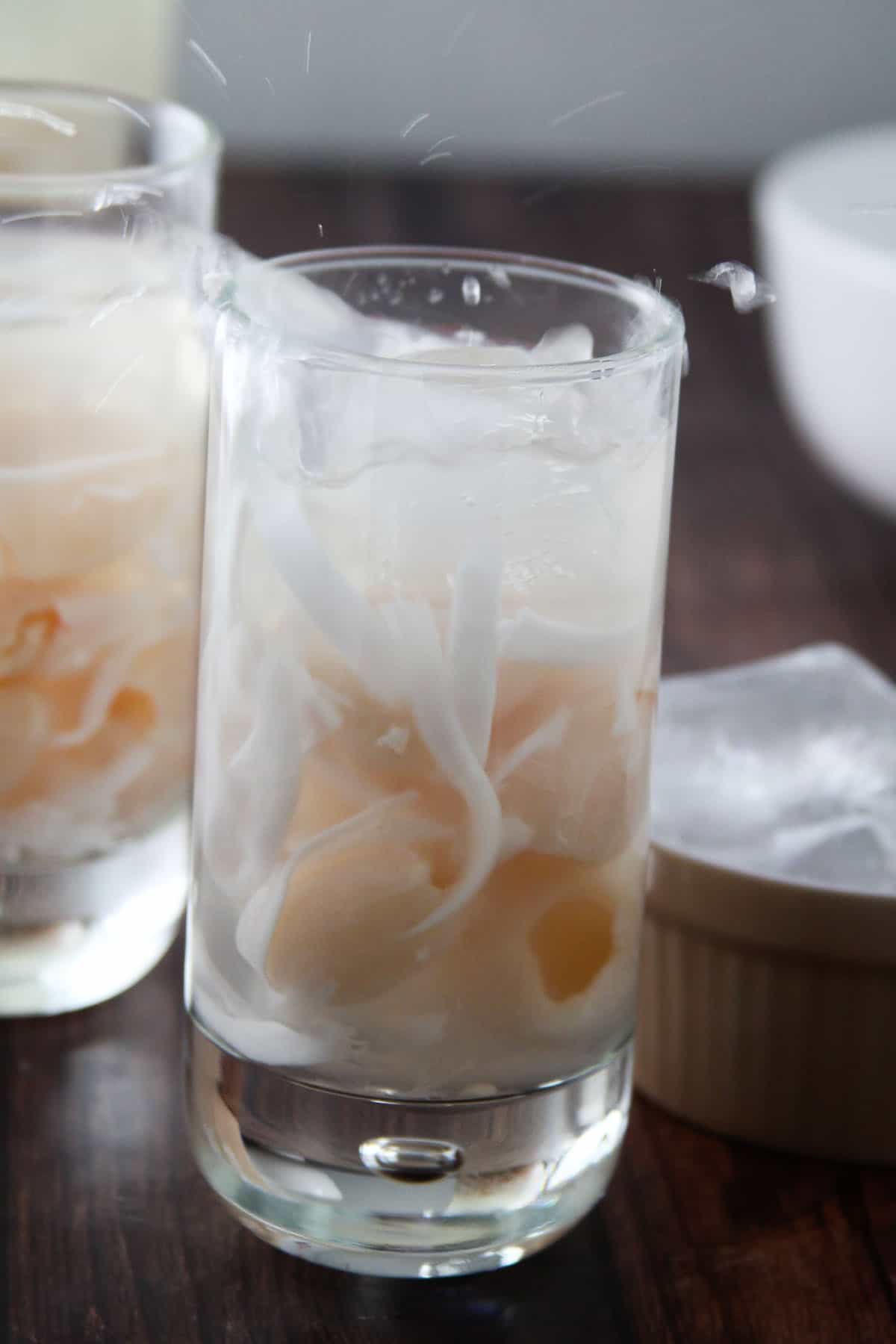 adding ice to glass of Buko Lychee Juice