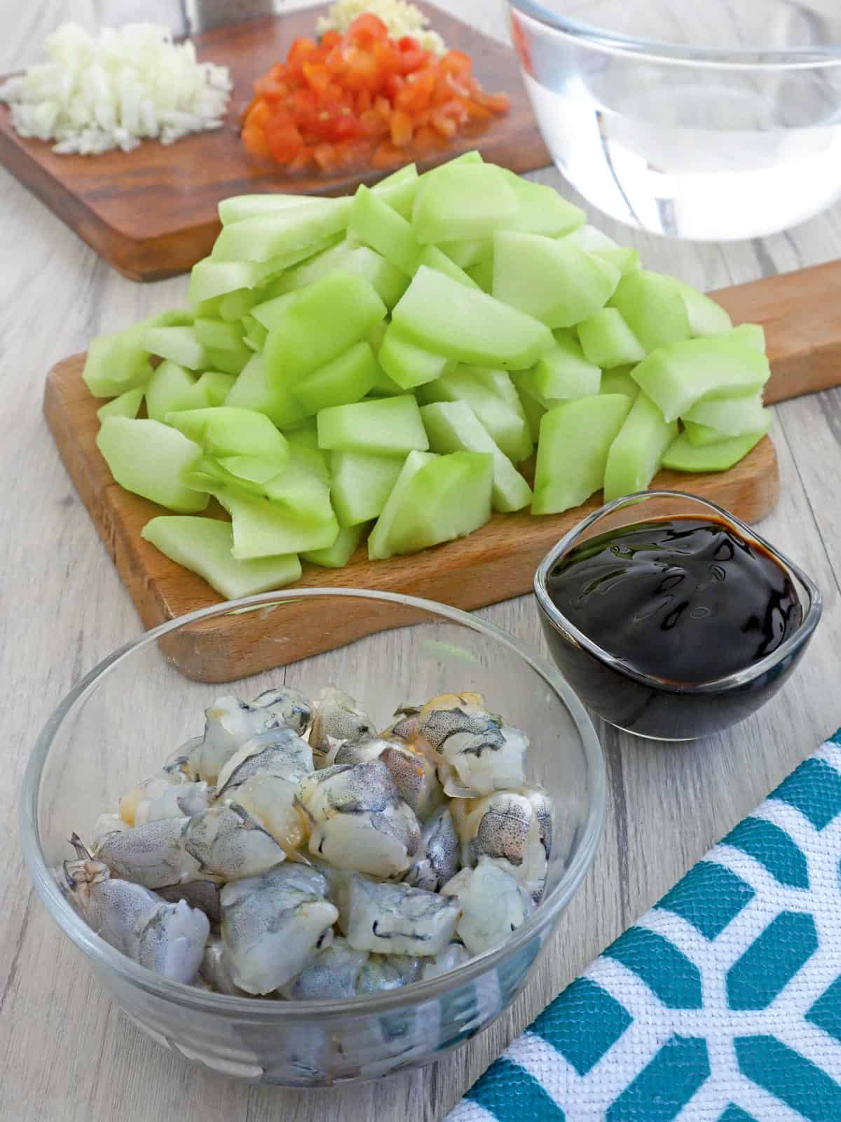 peeled and sliced sayote, chopped shrimp, oyster sauce, chopped tomatoes, onions, garlic, and water