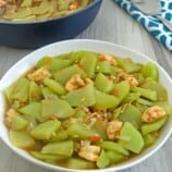 Ginisang Sayote with shrimp in a white serving bowl