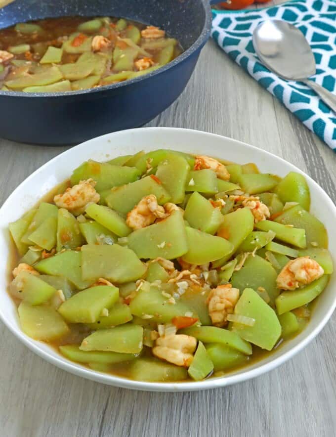 Ginisang Sayote with shrimp in a white serving bowl