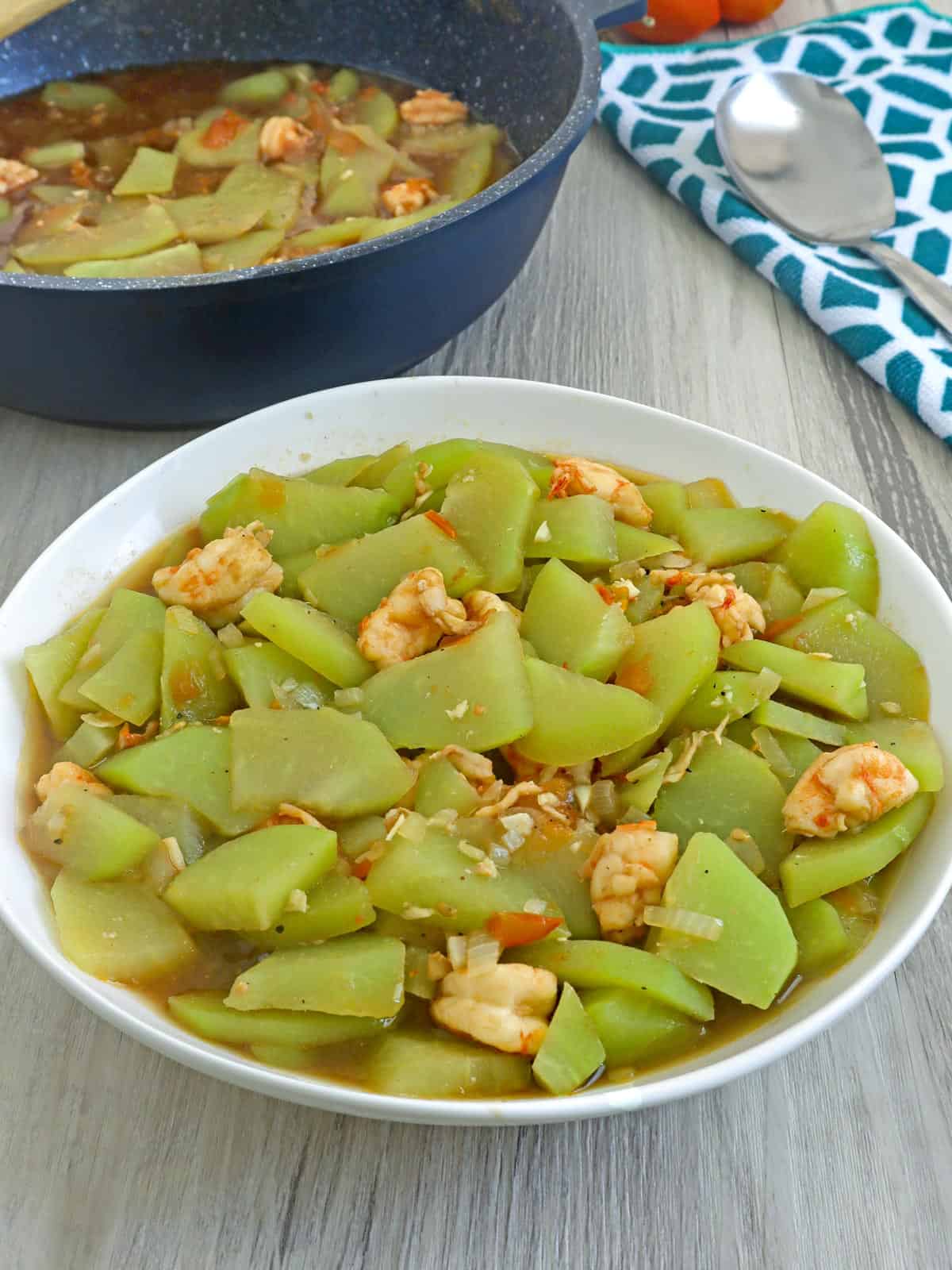 Ginisang Sayote with shrimp in a white serving bowl