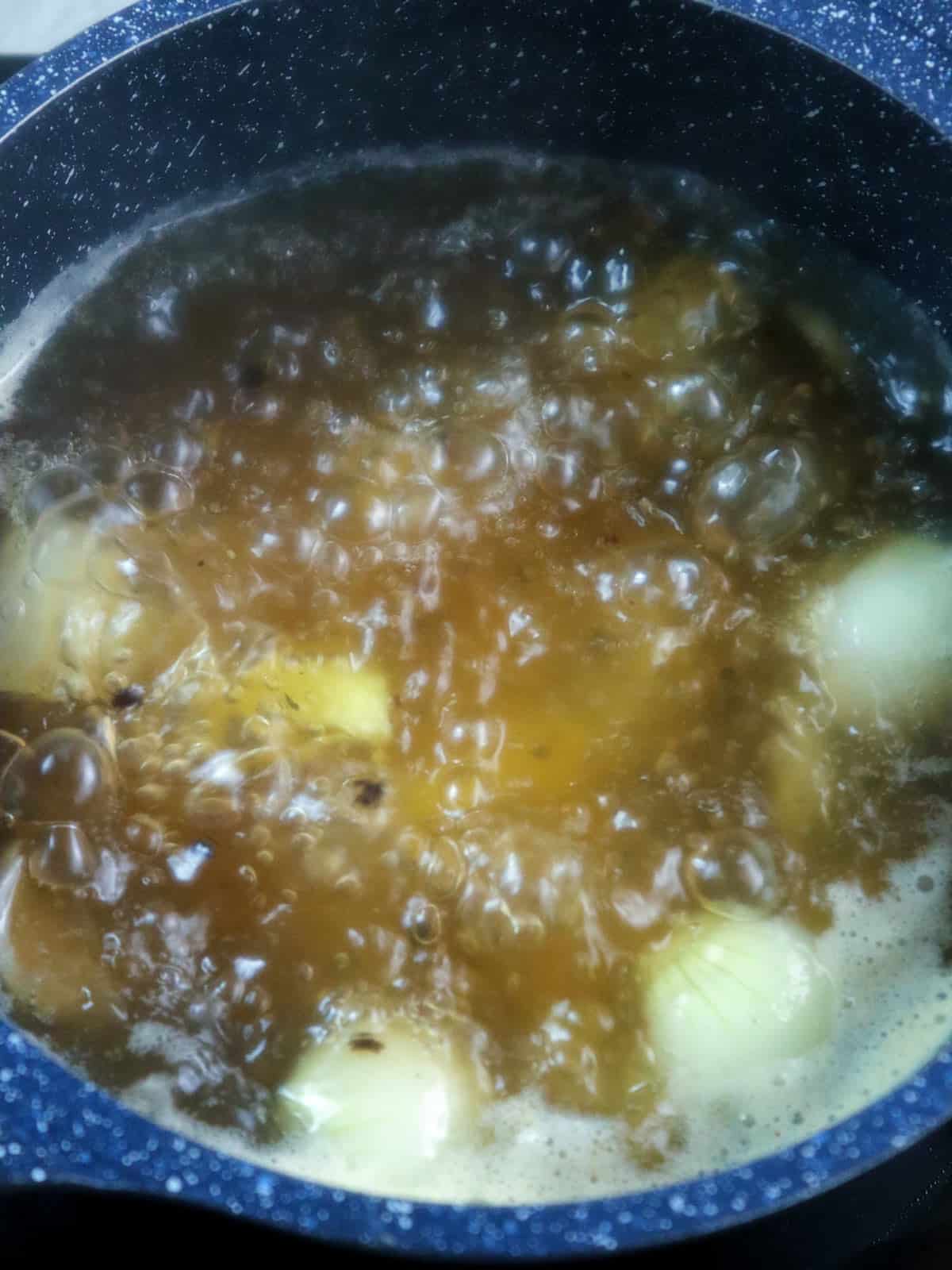 boiling potatoes with onions and pepper corns in a pot