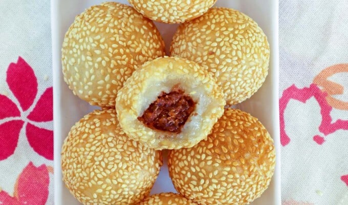 sesame balls with red bean filling on a white plate