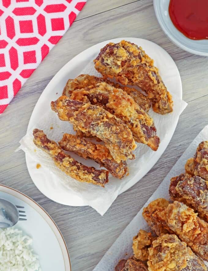 crispy pork ribs on white serving platter