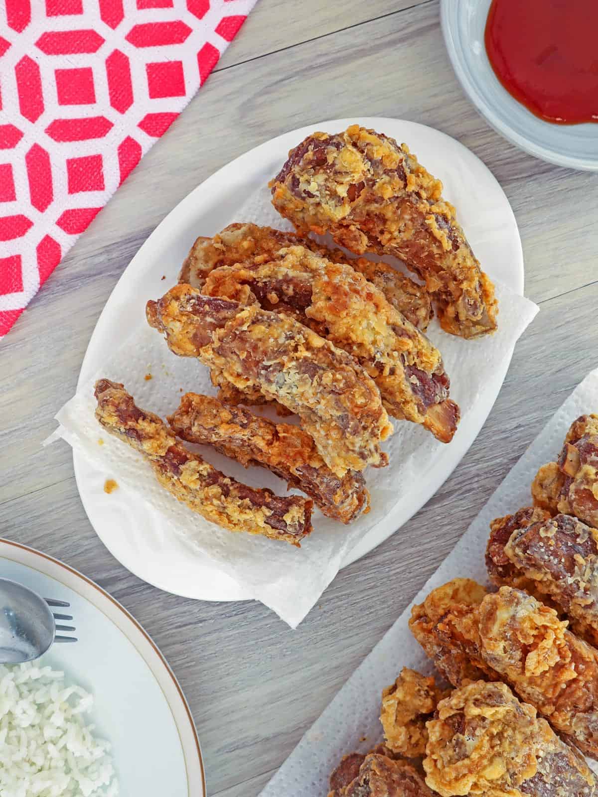 crispy pork ribs on white serving platter