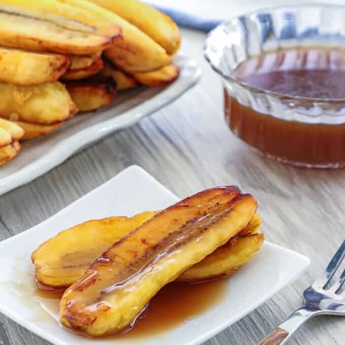 Fried Bananas with Salted Coconut Caramel Sauce on a white serving plate