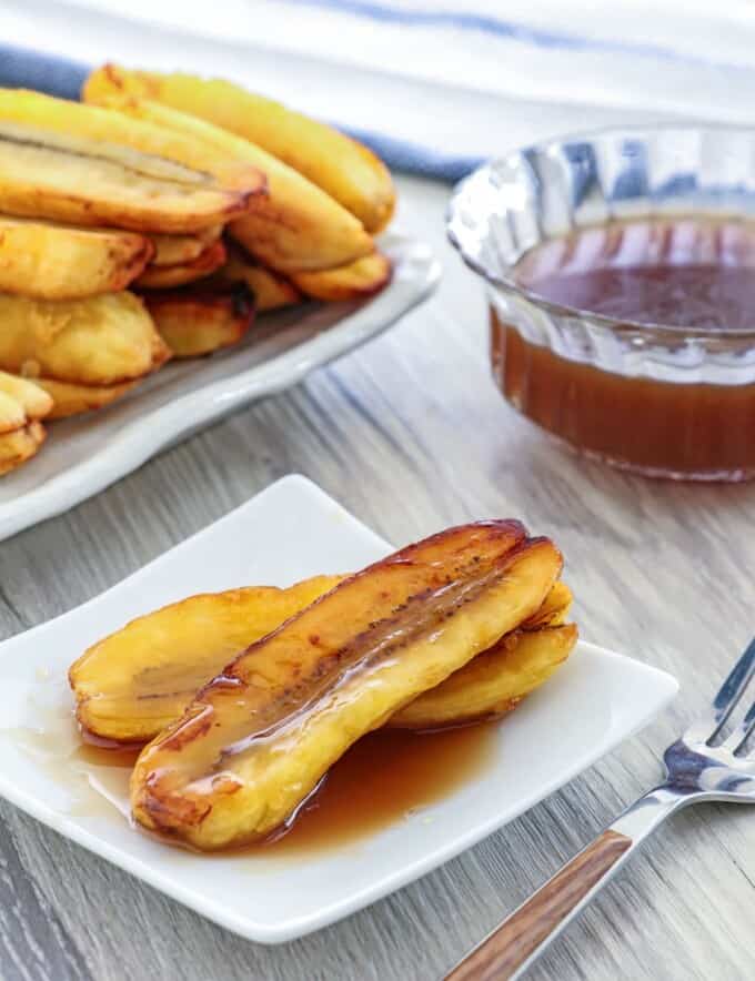 Fried Bananas with Salted Coconut Caramel Sauce on a white serving plate