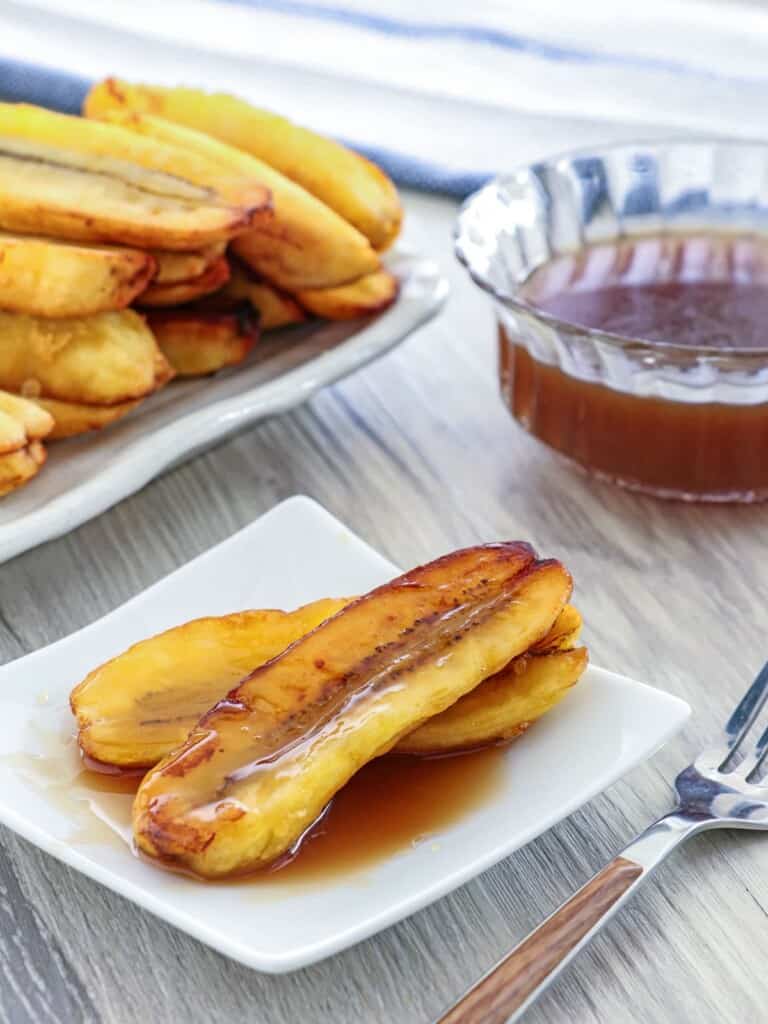 Fried Bananas with Salted Coconut Caramel Sauce on a white serving plate
