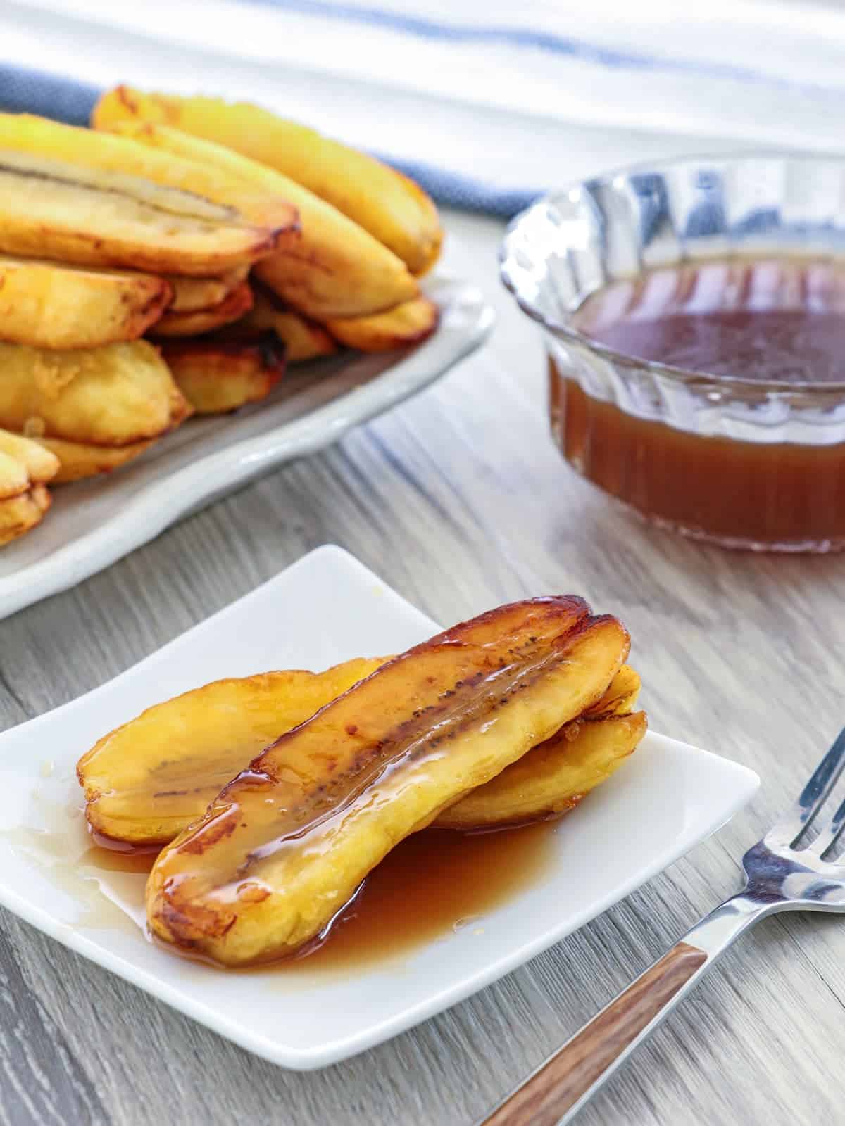 Fried Bananas with Salted Coconut Caramel Sauce on a white serving plate