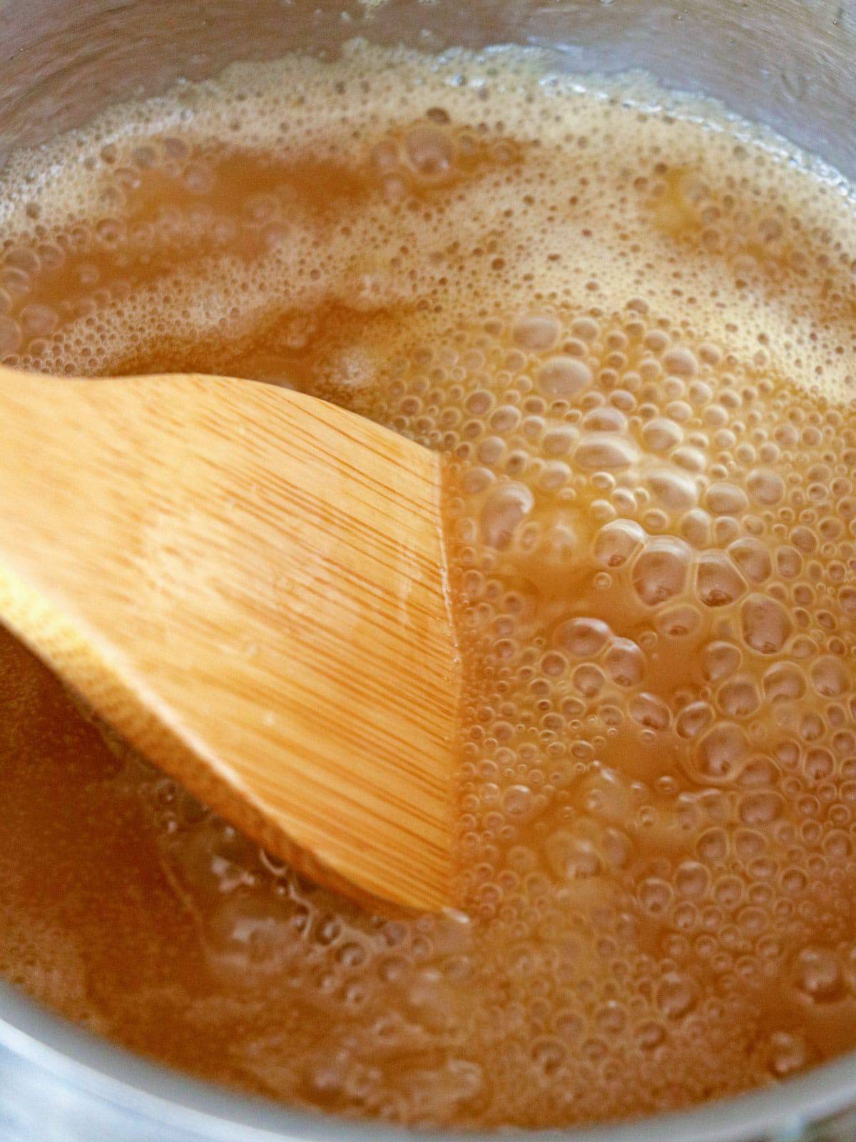 cooking caramel sauce in a saucepan