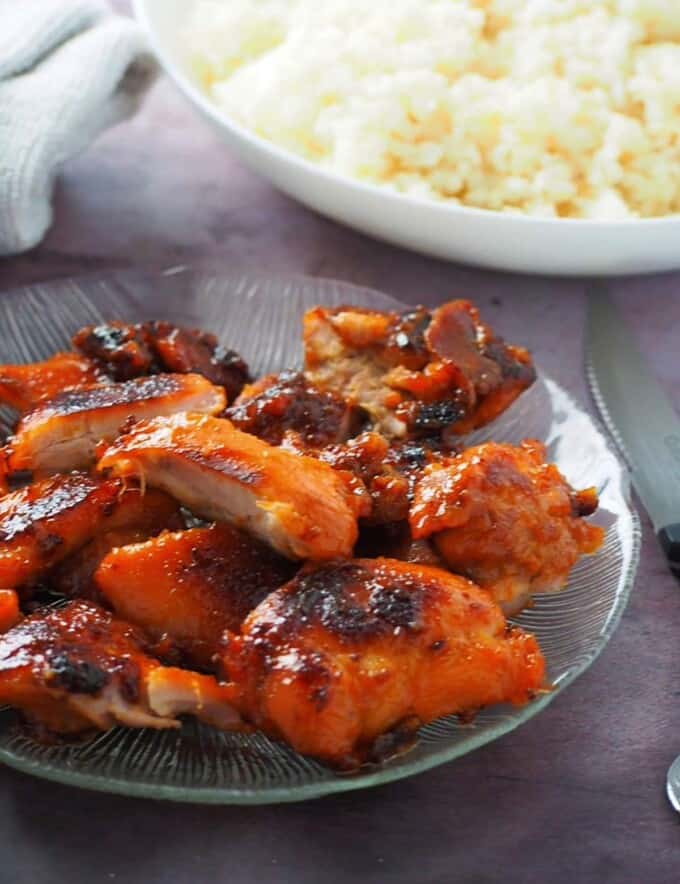 cut up Chicken Tocino on a clear glass serving platter